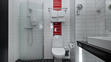 Un baño moderno con cabina de ducha de vidrio, inodoro blanco y lavamanos negro.