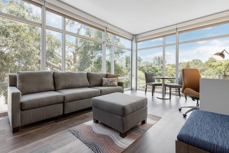 Corner King Suite with Sofa Bed | Hypo-allergenic bedding, desk, laptop workspace, iron/ironing board. Cambria Hotel Mount Pleasant – Charleston