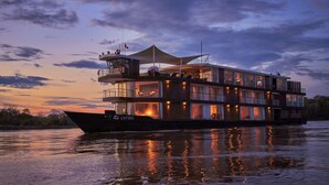 A large, multi-story boat with a covered upper deck, a control tower, and a cabin area with windows. - Jungle Experiences Zafiro (Nauta)