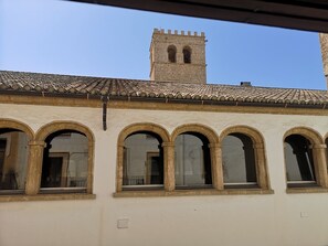 A building with a tiled roof and a tower with two arched windows. - Hotel Triskel (Javea)