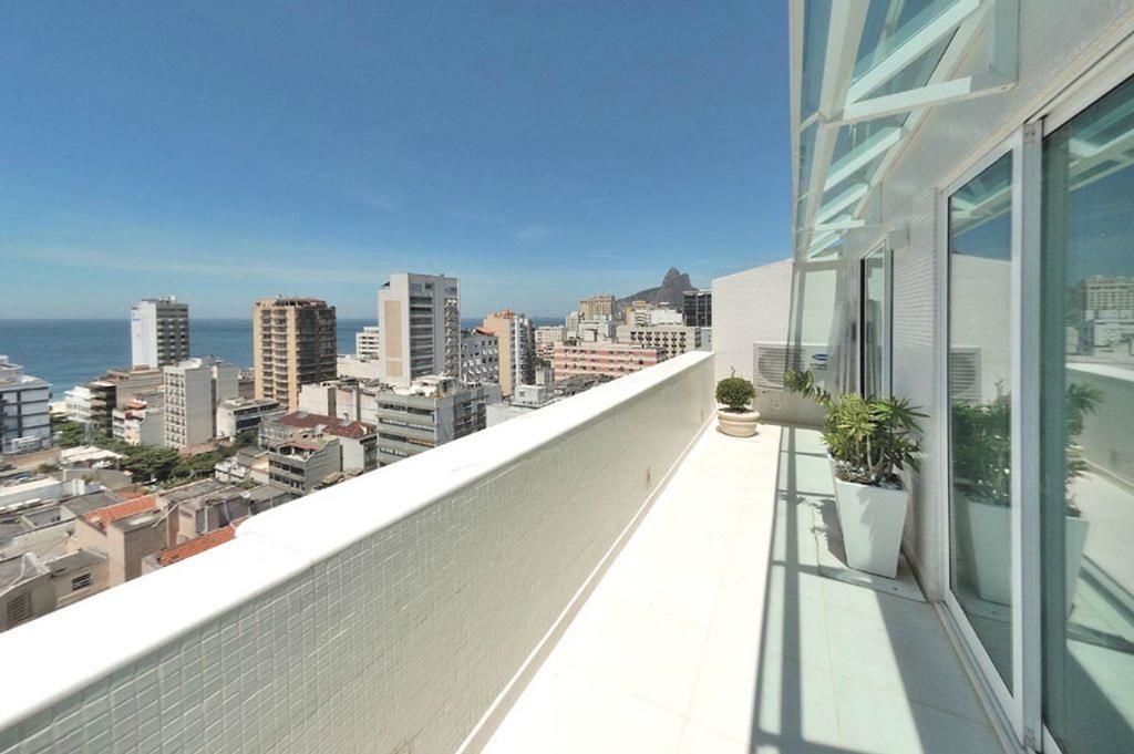 A cityscape view from a balcony with a clear sky.