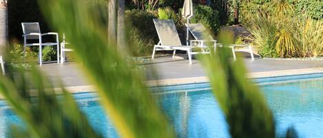 Seasonal outdoor pool, pool umbrellas, pool loungers