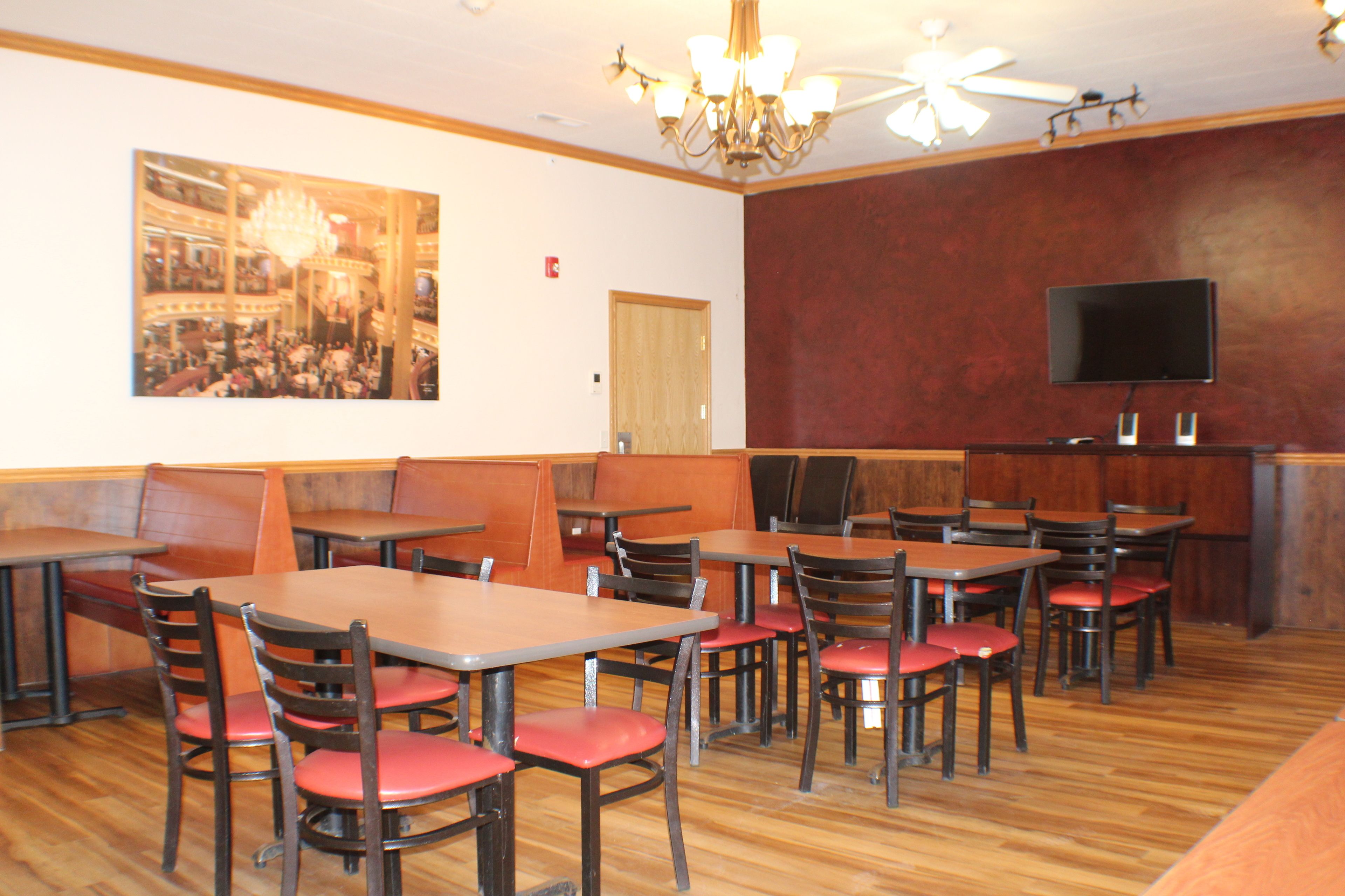 A restaurant interior with booths, tables, and chairs.