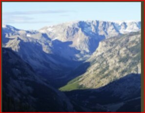 A mountainous landscape with rugged terrain and a valley. - Gallagher's Irish Rose (Red Lodge)