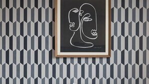 A bed with white bedding and pillows, a geometric patterned wallpaper, and a framed artwork above the bed. - Busan No.25 Yongho (Busan)