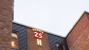 A hotel with a modern brick facade and a prominent illuminated sign reading "HOTEL 25". - Busan No.25 Yongho (Busan)