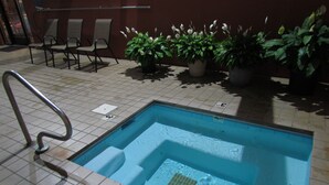 A swimming pool with a 3 FT depth marking, surrounded by potted plants and chairs. -  In Town with a Spectacular View - Walk to the Parkway! (Gatlinburg)