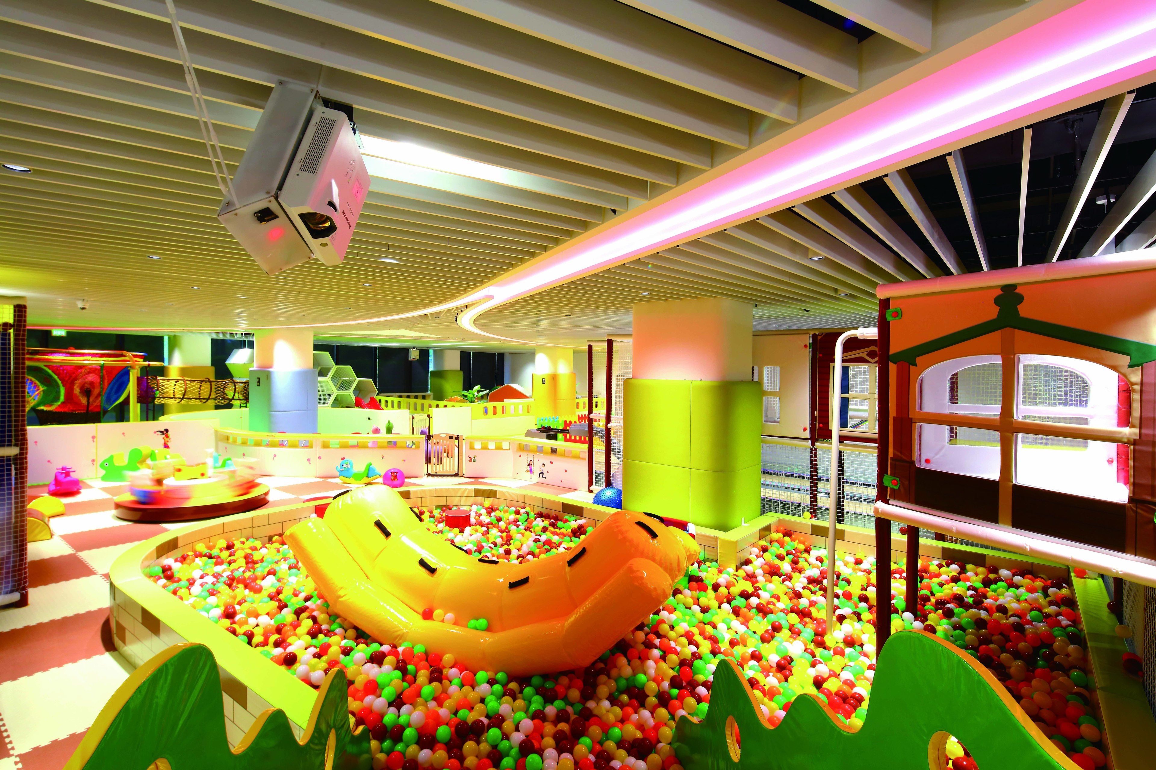 A children's play area with a ball pit, inflatable slide, and various play structures.
