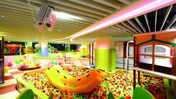 A children's play area with a ball pit, inflatable slide, and various play structures.