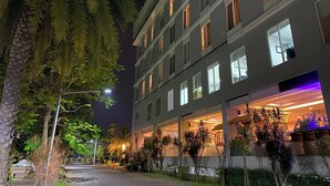 A multi-story hotel with illuminated windows and a well-lit entrance. - Ascent Premiere Pasuruan (Pasuruan)