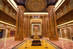 An ornate interior with a central altar, intricate woodwork, and a patterned ceiling. - ChengDu Trika Tsang International Hotel (Chengdu)