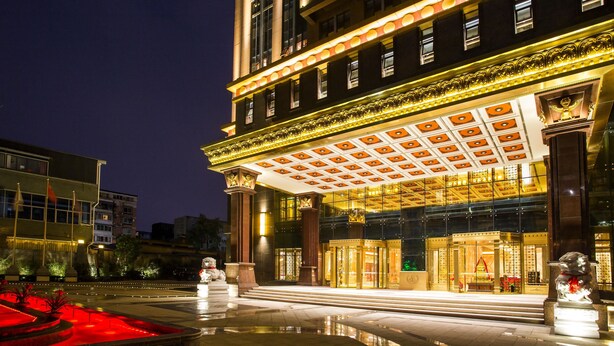 A grand hotel entrance with a large, ornate canopy and a well-lit facade. - ChengDu Trika Tsang International Hotel (Chengdu)
