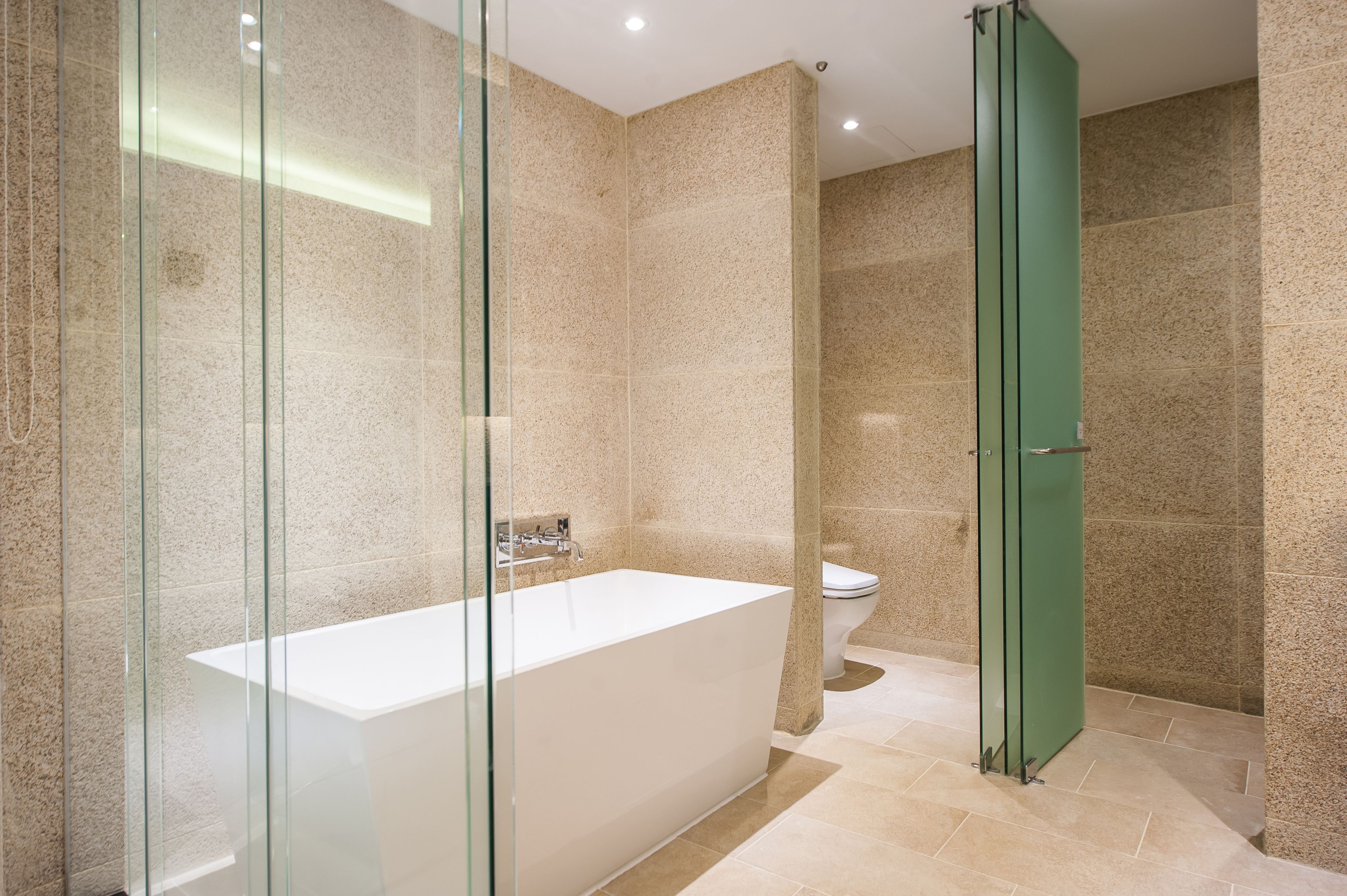 junior suite | bathroom | separate bathtub and shower, deep-soaking bathtub, hair dryer, bathrobes