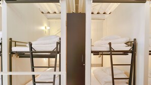 A room with bunk beds, a door, and a light fixture. - Chillulu Coffee & Hostel (Yokohama)