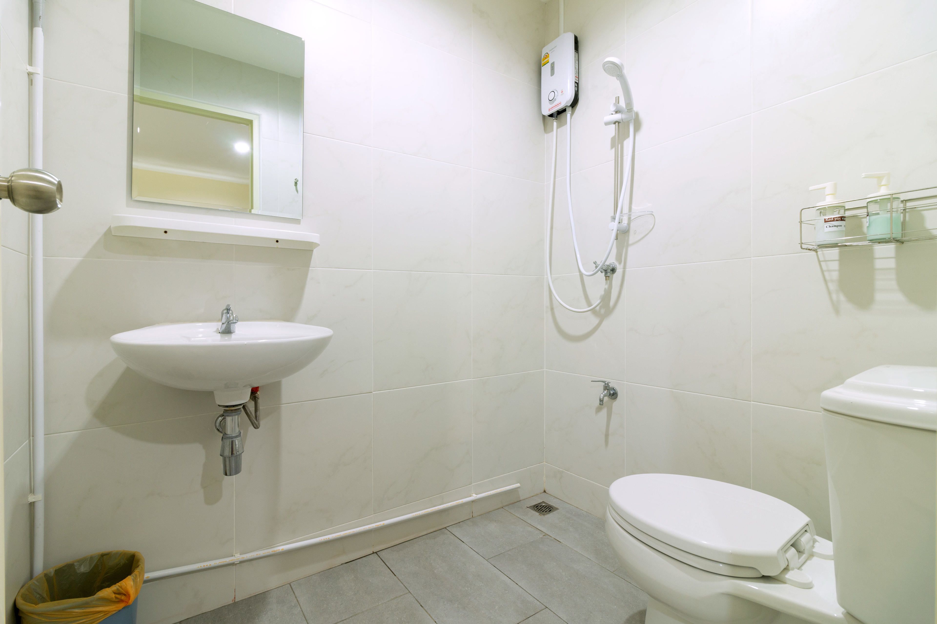 A bathroom with a sink, toilet, and shower.