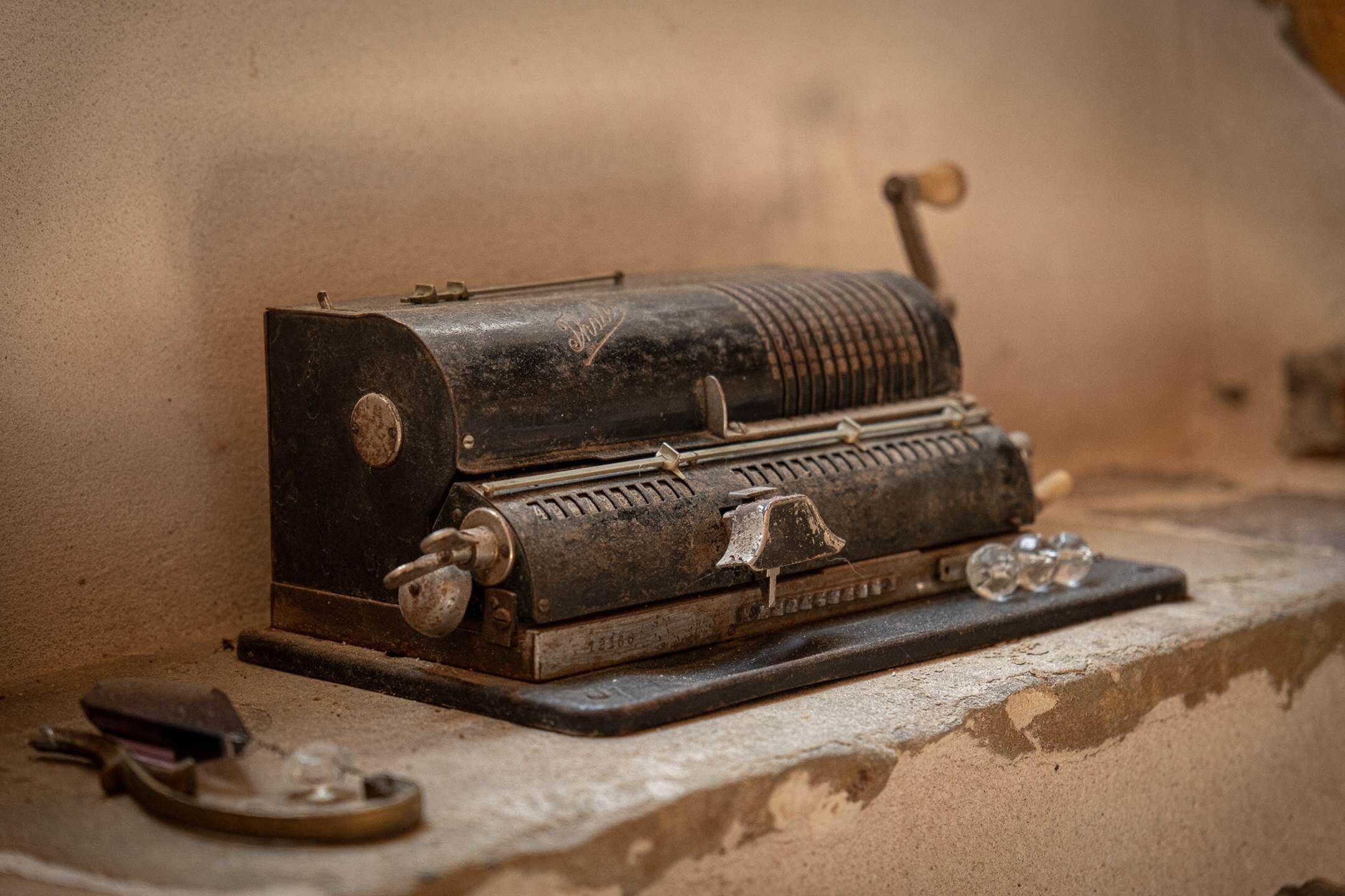 An antique typewriter on a stone surface.