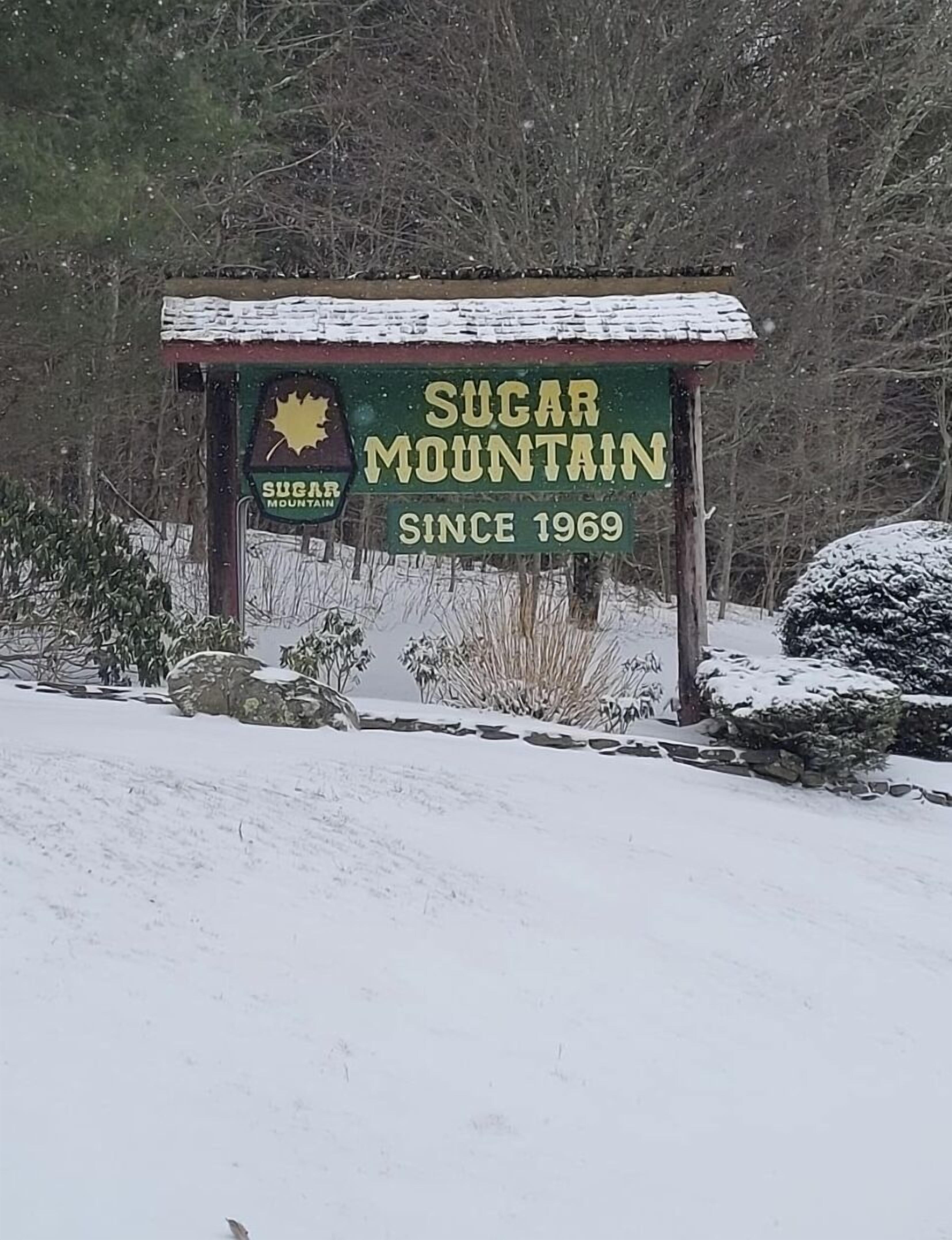 A sign for Sugar Mountain with a maple leaf logo, stating it has been established since 1969.