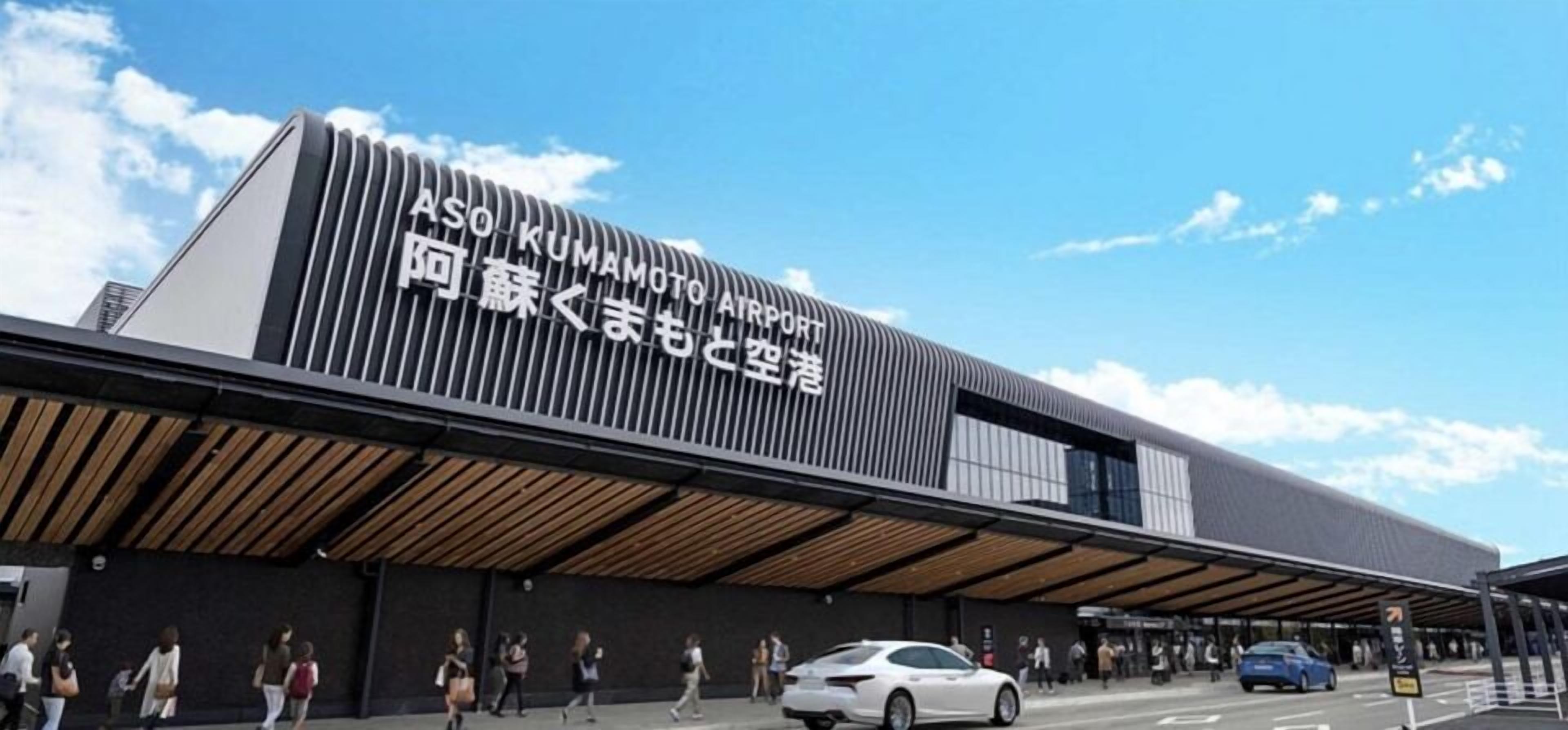A modern airport terminal with a prominent sign in both English and Japanese.