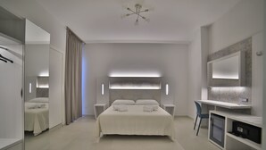 A modern bedroom with a large bed, bedside tables, a desk, and a mirror. - Hotel da Ettore (Porto Cesareo)