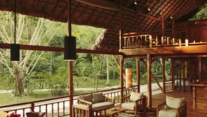 A wooden deck with seating and a view of the outdoors. - Barefoot at Havelock (Port Blair)