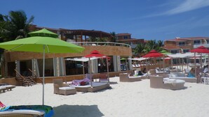 A beachside resort with multiple lounge areas, sunbeds, and umbrellas. - Beach Resort, Playa Del Carmen, Mexico, Spectacular View! 333S (Playa del Carmen, QRO)