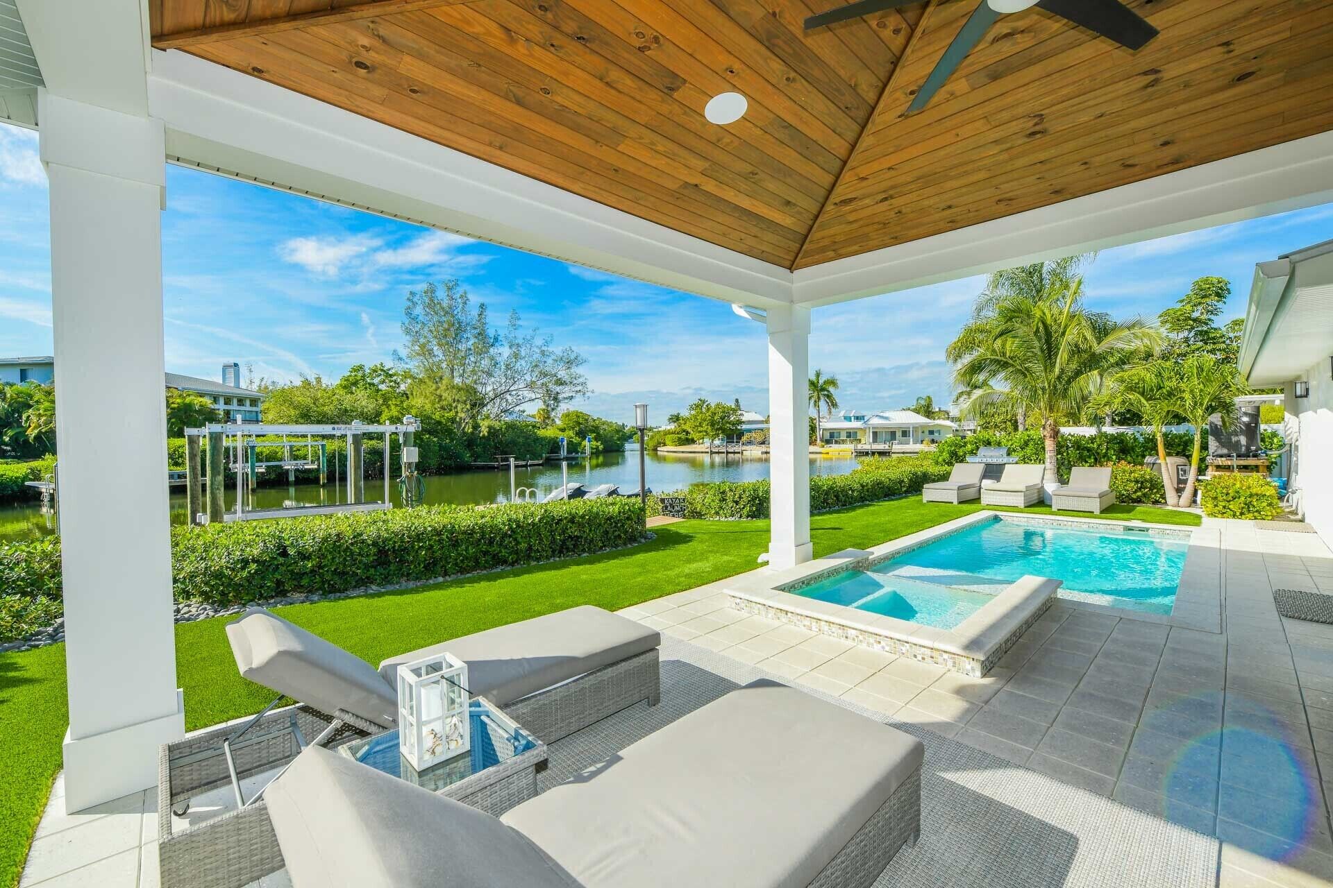 Stunning Canal front Luxury home! Beautiful tropical backyard Pool and Spa!