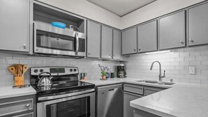 A modern kitchen with stainless steel appliances, a dishwasher, and a sink. - RMR: Gros Ventre A5 Condo in Teton Village (Teton Village)
