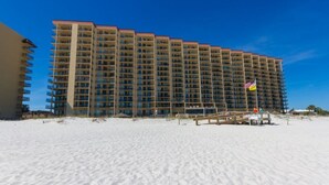 A large hotel with multiple floors and balconies, situated on a sandy beach. - Phoenix V 202 (Orange Beach)