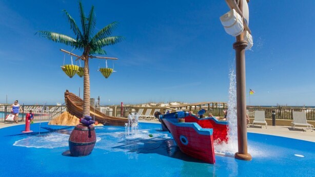 A water play area with a palm tree, a ship, and a fountain. - Phoenix V 202 (Orange Beach)