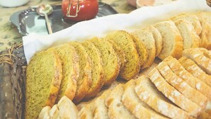 A breakfast buffet with various breads, jams, and pastries.