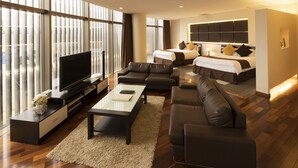 A modern hotel room with a large bed, a sofa, a TV, and a desk. - Villa Terrace Omura Hotels & Resorts (Omura)