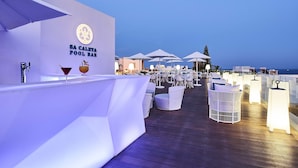A pool bar with a sign reading "SA CALFTA POOL BAR" and outdoor seating with umbrellas. - Eurostars Ibiza (Ibiza Town)