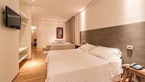 A hotel room with a bed, bedside table, and a TV mounted on the wall. - Hotel Radice (Civitanova Marche)