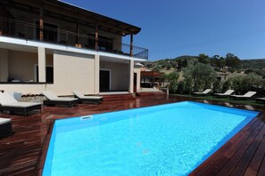 Piscine extérieure en saison, chaises longues