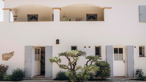 A two-story building with a white facade, grey shutters, and a tiled roof. - La Villa d'Andrea (Ramatuelle)