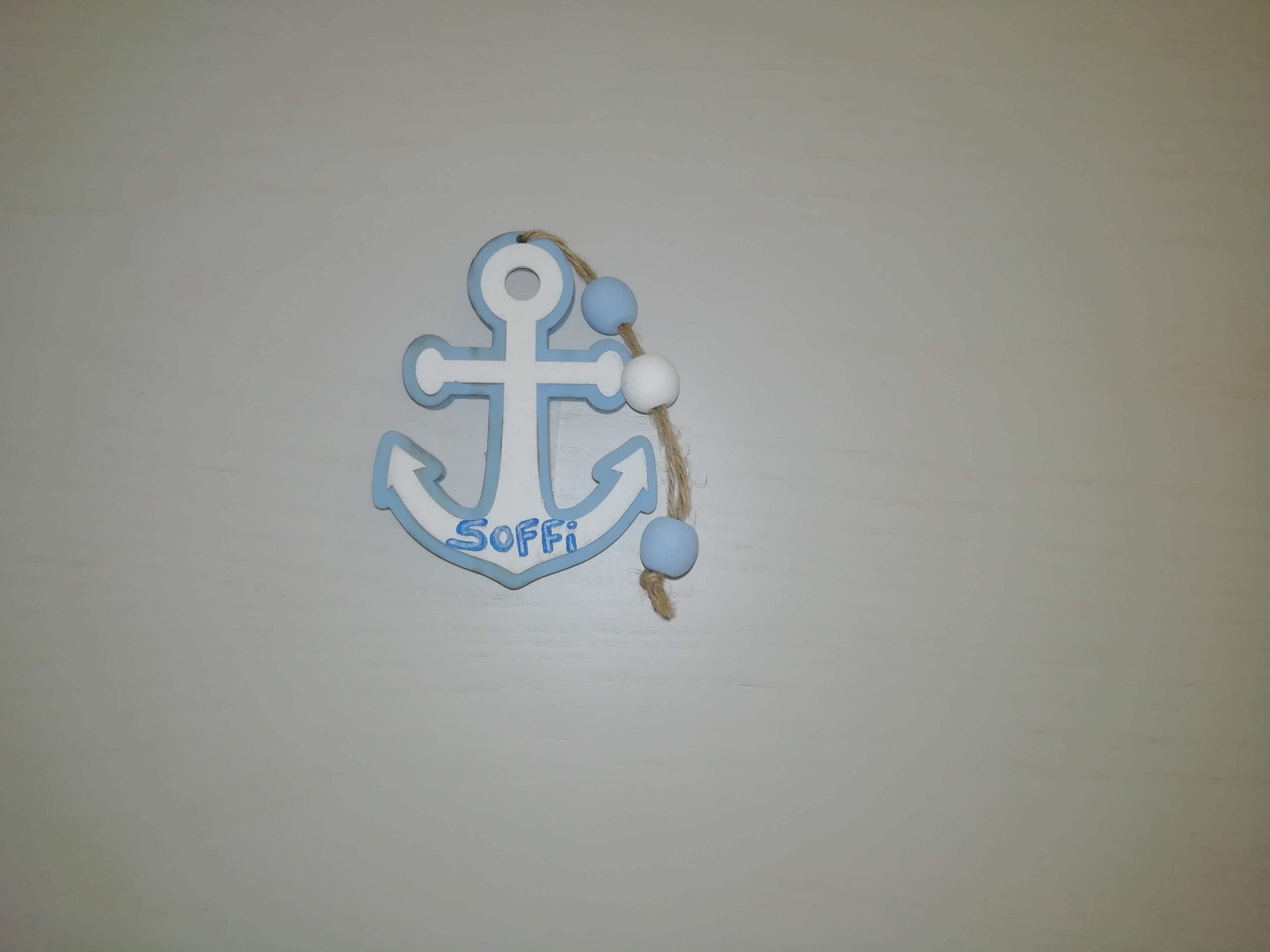 A decorative anchor with the name "SOFFI" on a plain wall.