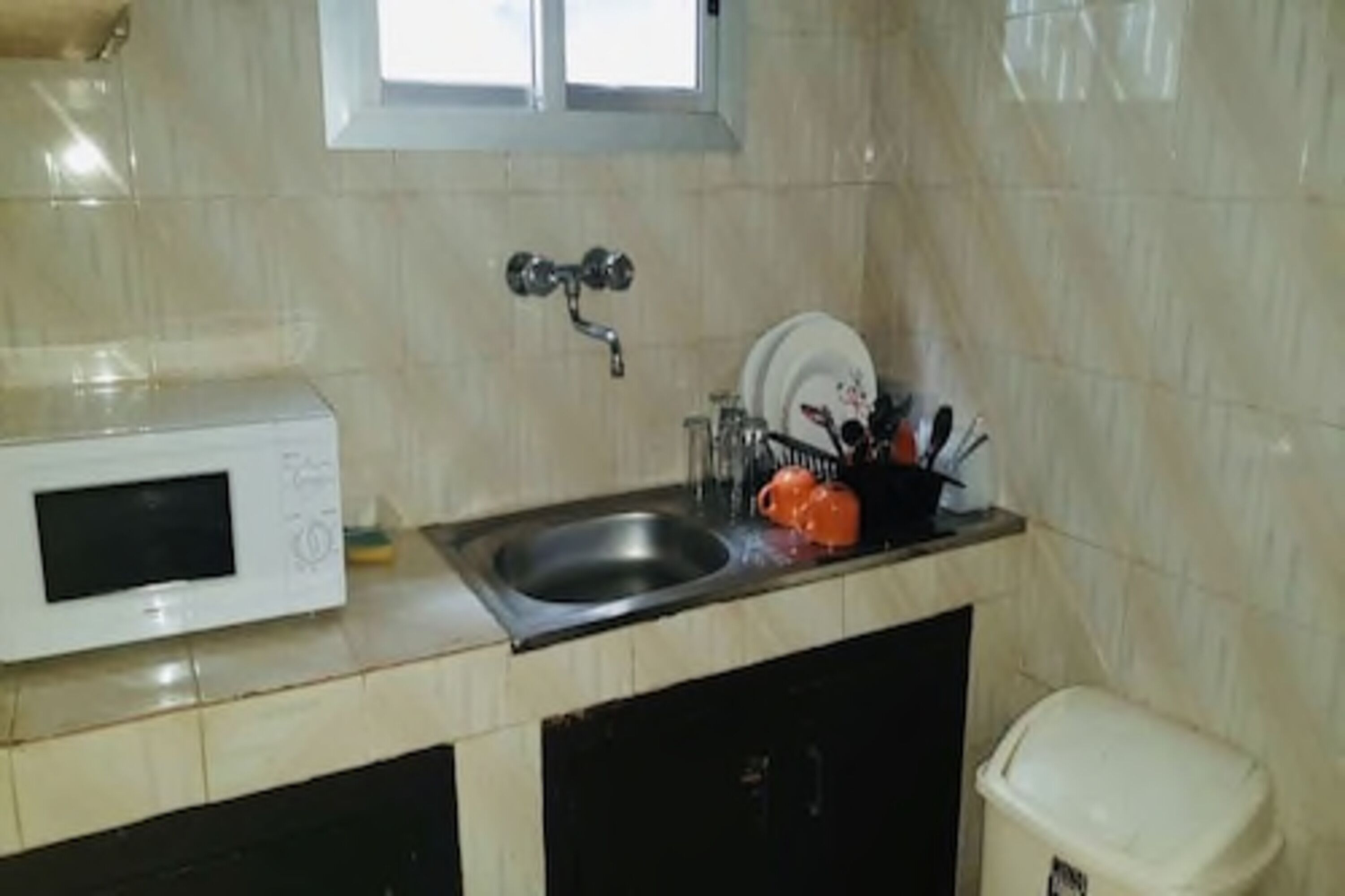 A kitchen with a microwave, sink, and dishwasher.