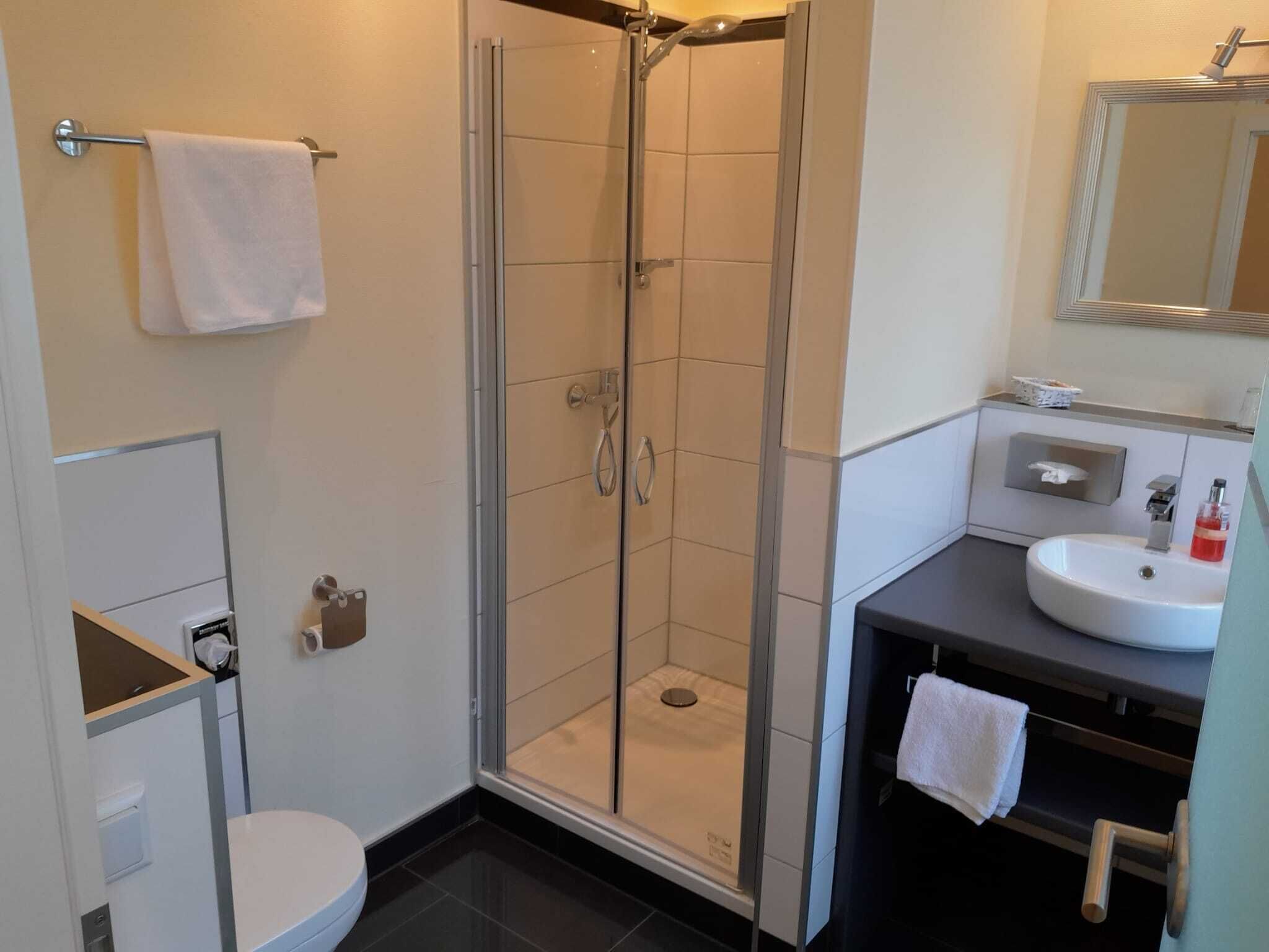 comfort single room, 1 queen bed | bathroom | shower, hair dryer, towels