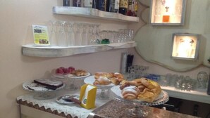 A buffet area with various pastries and desserts on display.