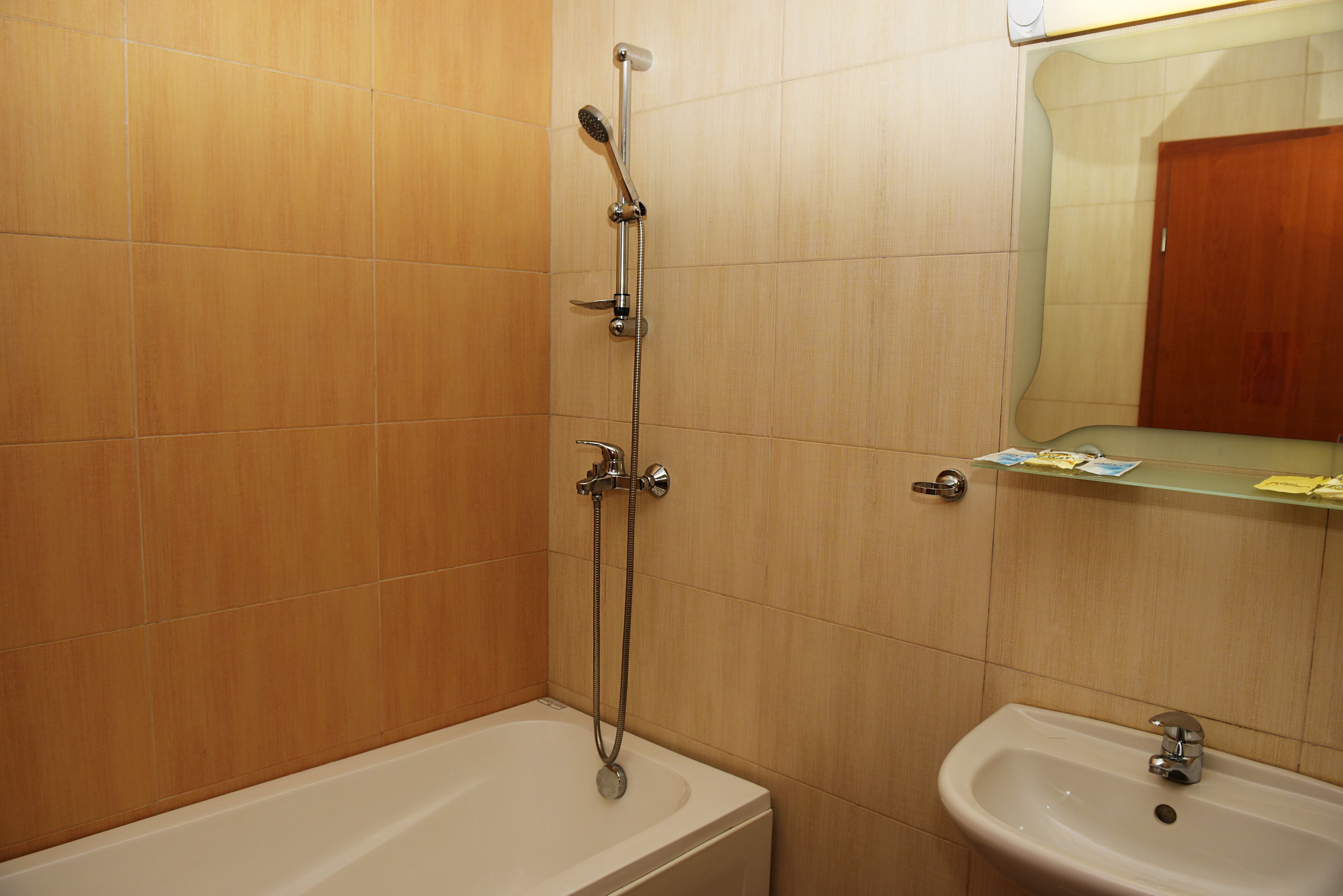 A bathroom with a bathtub, a shower, and a sink.