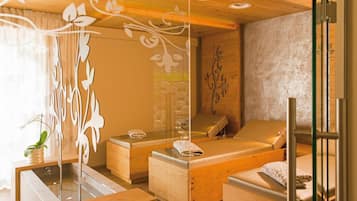 A spa room with wooden furniture, a glass partition, and decorative wall art.