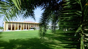 A large building with a sign reading "STARDOM RESORT". - Stardom Resort (Jaipur)