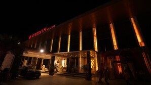 A hotel entrance with a modern design, featuring illuminated columns and a prominent sign. - Stardom Resort (Jaipur)