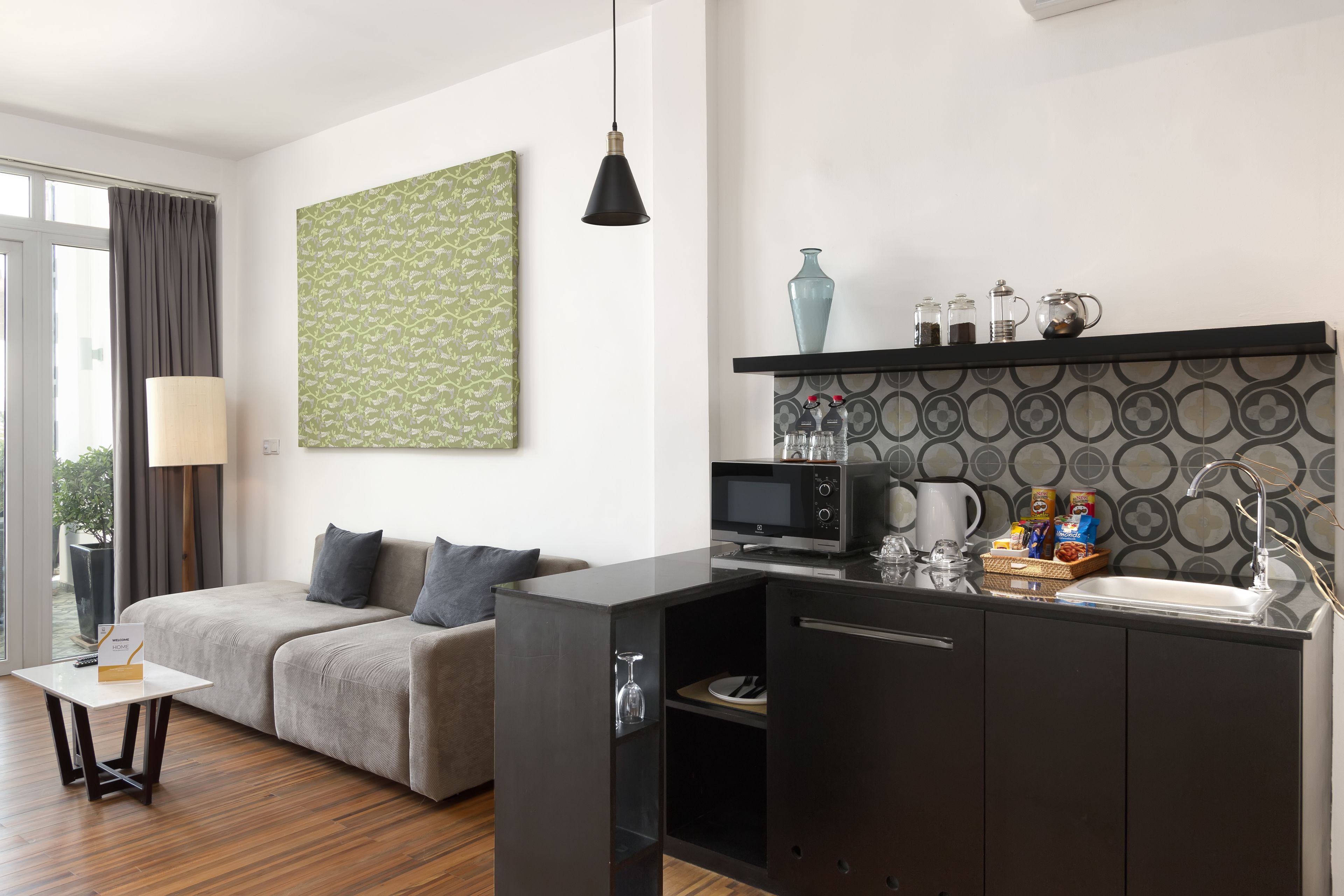 A compact living space with a kitchenette, a sofa, a coffee table, and a dining area.