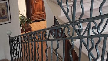 A staircase with ornate metal railings and a wooden handrail.