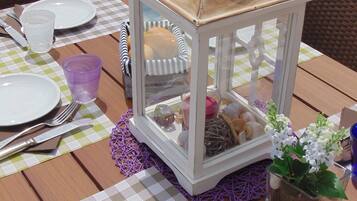 A table set with plates, cutlery, and a lantern.