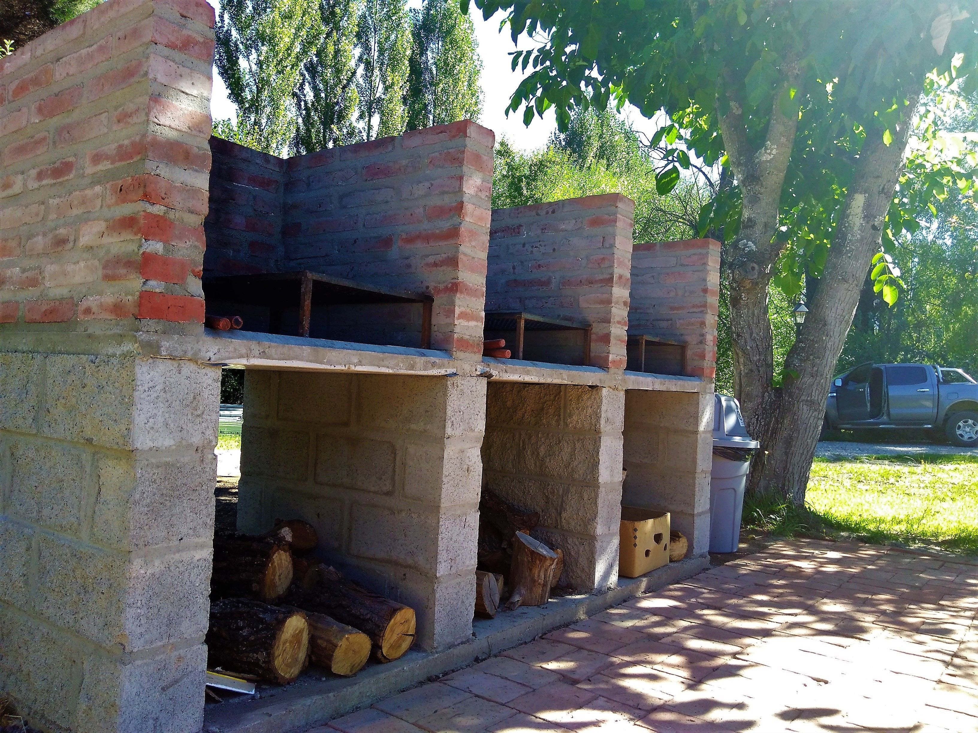 A brick-built outdoor structure with multiple compartments, possibly for storage or as a barbecue area.
