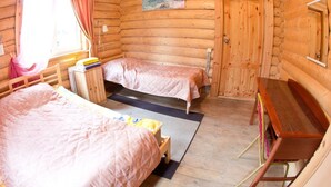 A wooden cabin room with two beds, a desk, and a painting on the wall. - Baza otdikha Zhuravushka (Sosnovskoye)