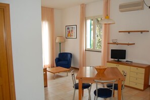 Standard Apartment, Courtyard View | Living room | TV