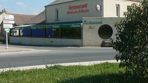 A building with a sign indicating it is a hotel and a restaurant.